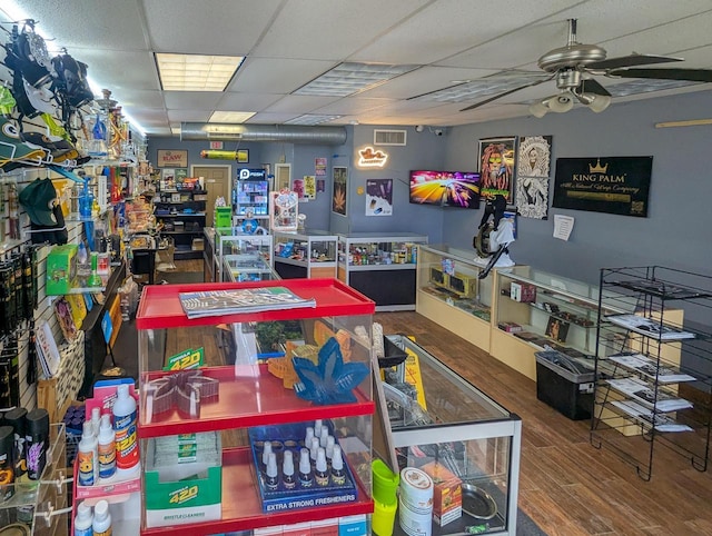 game room featuring hardwood / wood-style flooring, a paneled ceiling, and ceiling fan