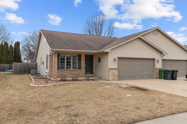 ranch-style house featuring a garage, central AC, and a front lawn