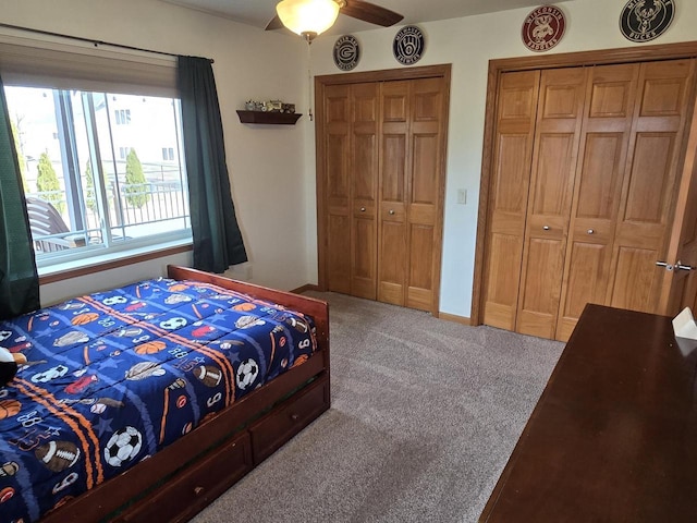 bedroom featuring multiple closets, carpet, and ceiling fan