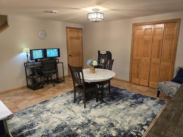 dining room featuring a textured ceiling