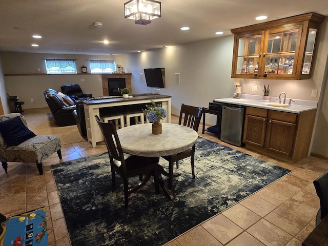 dining room featuring light tile patterned floors and indoor wet bar