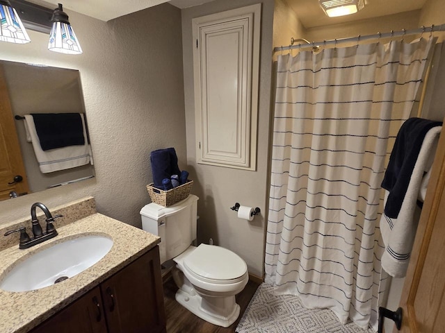 bathroom with a shower with shower curtain, vanity, toilet, and hardwood / wood-style floors