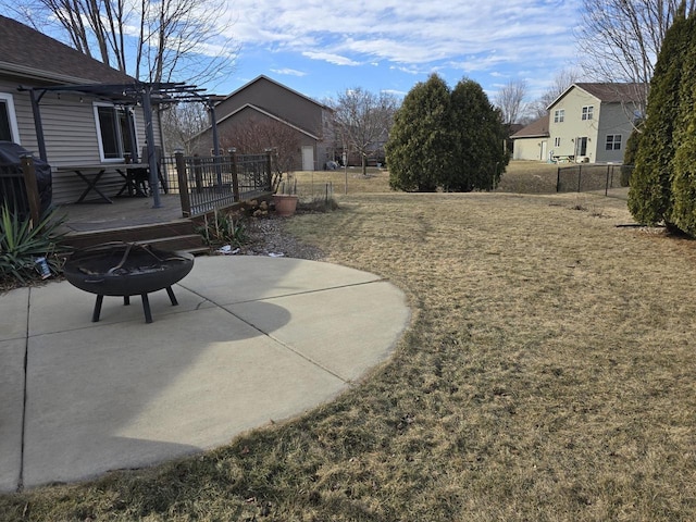 view of yard with a deck, a patio area, and a fire pit