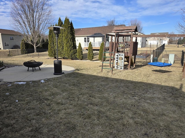 view of play area featuring a yard and a fire pit