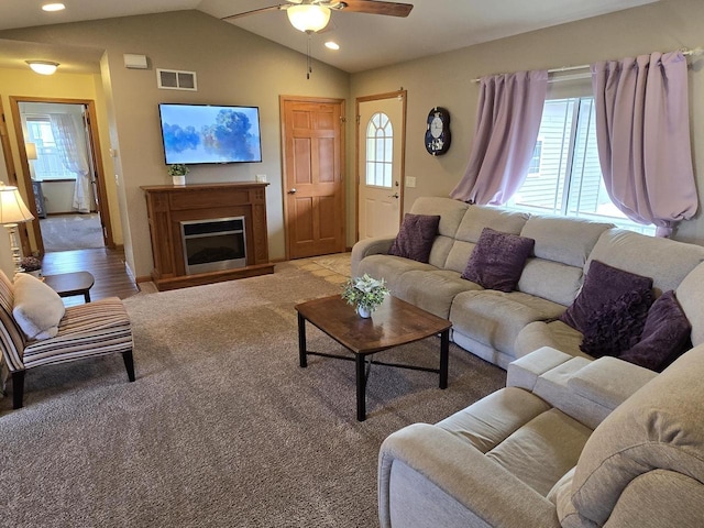 living room featuring ceiling fan, lofted ceiling, and light carpet