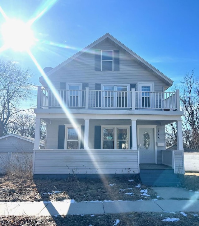 view of front facade with a balcony and covered porch