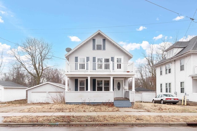 front of property with an outbuilding, a balcony, a garage, and a porch