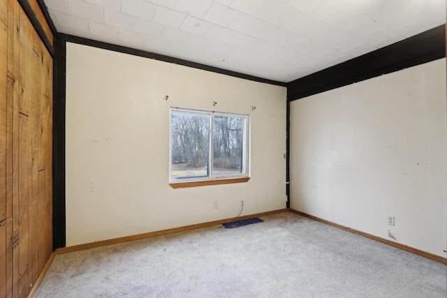 spare room featuring light colored carpet