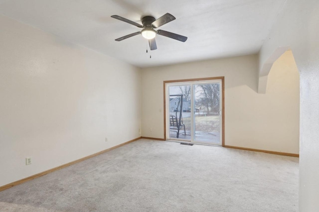 spare room with ceiling fan and light colored carpet