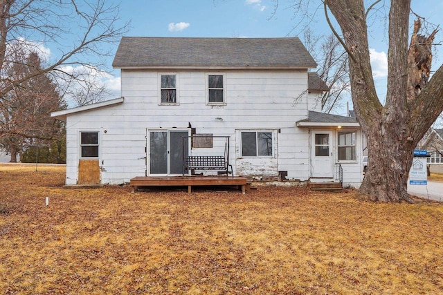 back of property featuring a wooden deck