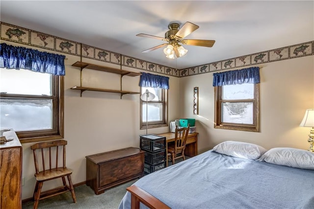 carpeted bedroom featuring multiple windows and ceiling fan