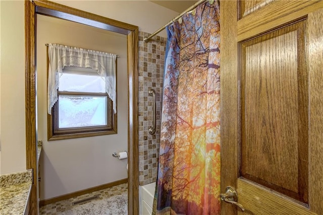 bathroom featuring vanity and shower / tub combo