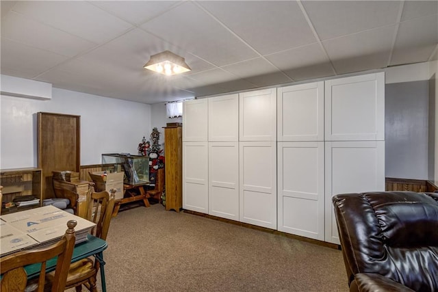 carpeted office with a drop ceiling
