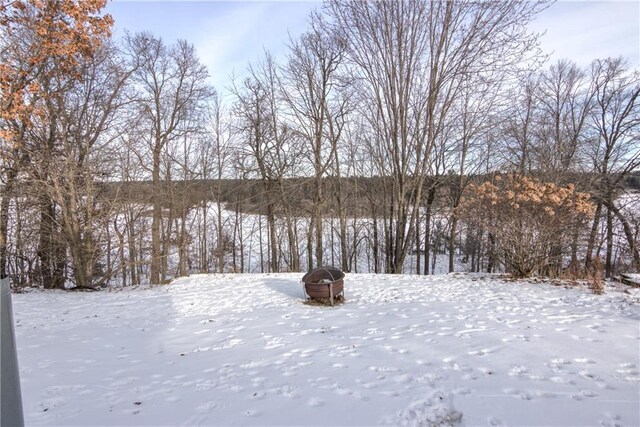 snowy yard featuring a fire pit