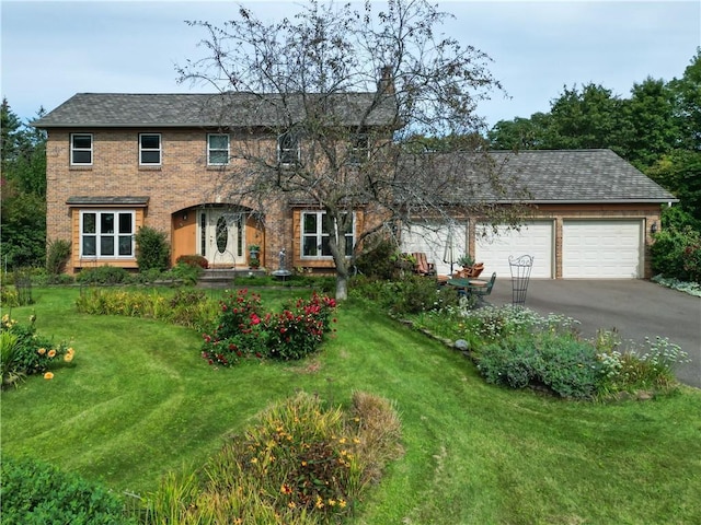 view of front of home with a garage and a front yard