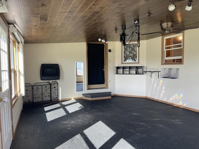 unfurnished living room with heating unit and wooden ceiling