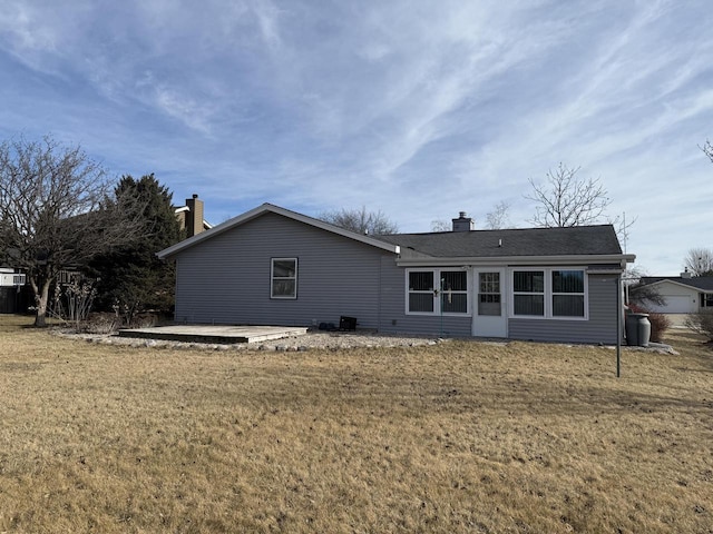 rear view of house featuring a lawn