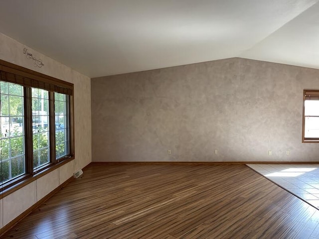 interior space featuring lofted ceiling and dark hardwood / wood-style flooring