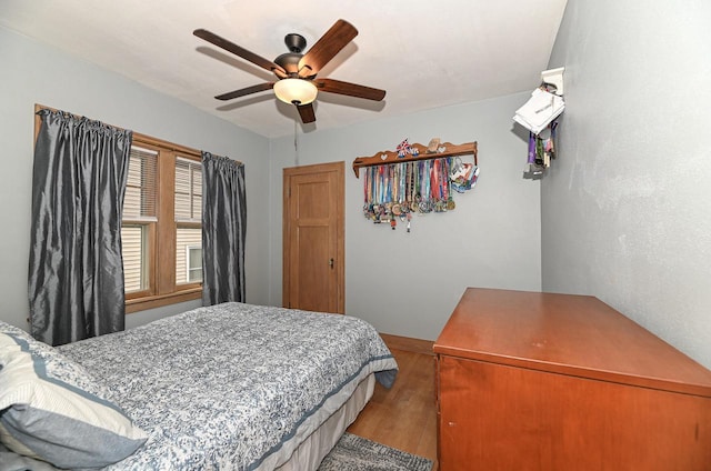 bedroom with ceiling fan and wood-type flooring