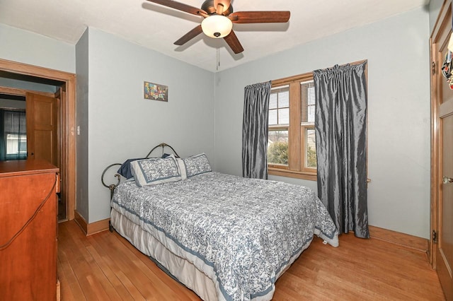 bedroom with ceiling fan and light hardwood / wood-style flooring