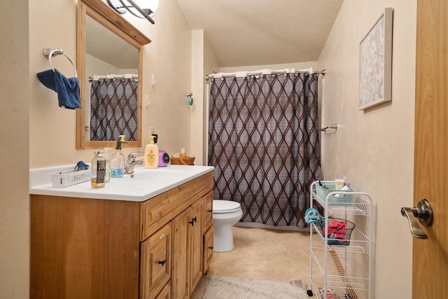 bathroom with vanity, a shower with shower curtain, and toilet