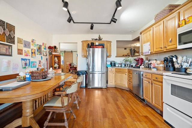 kitchen with track lighting, stainless steel appliances, light hardwood / wood-style flooring, and light brown cabinets