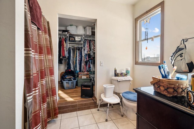 bathroom with toilet and tile patterned flooring