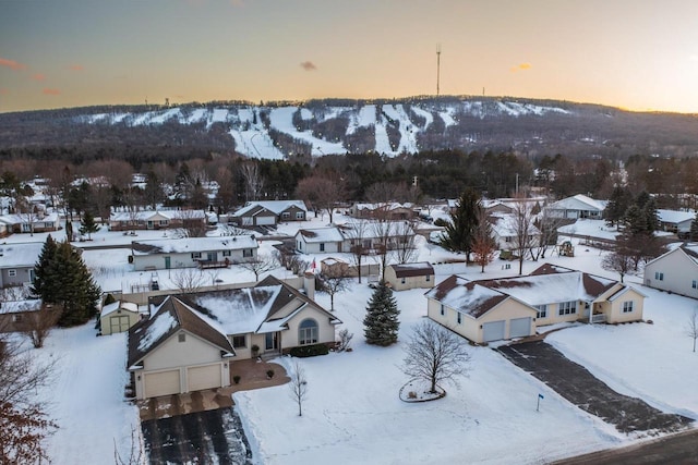 snowy aerial view featuring a mountain view