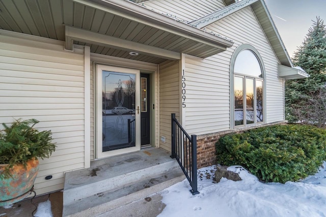 view of snow covered property entrance