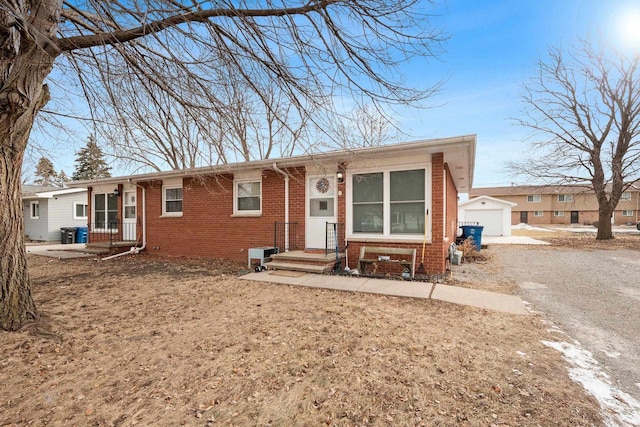 view of front of house with a garage and an outdoor structure