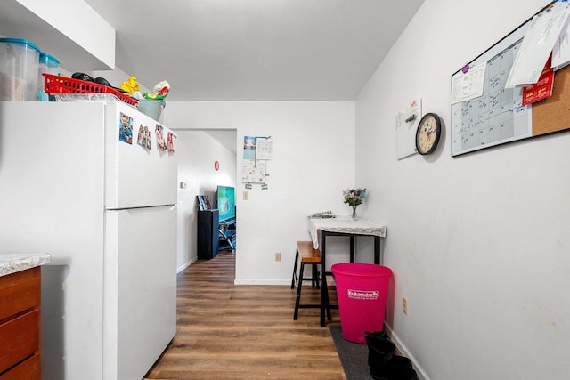 kitchen featuring dark hardwood / wood-style flooring and white fridge