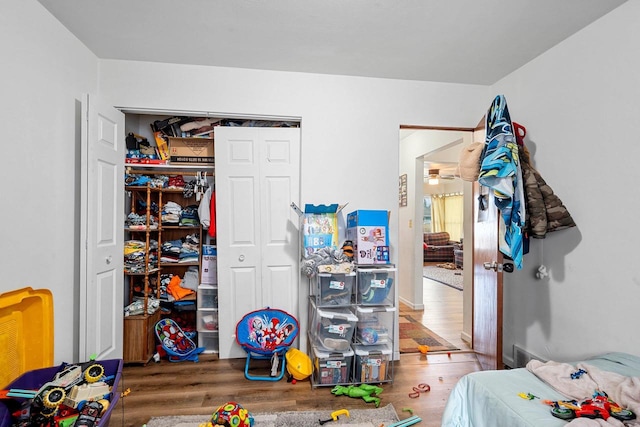 bedroom with wood-type flooring and a closet