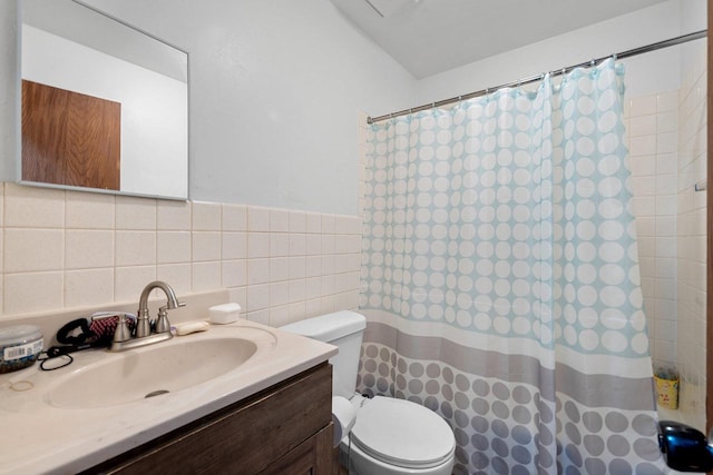 bathroom featuring vanity, toilet, a shower with shower curtain, and tile walls