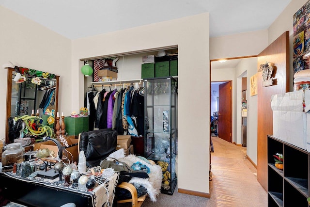 bedroom with light carpet and a closet