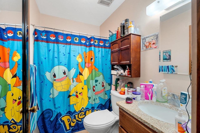 bathroom with vanity, curtained shower, and toilet