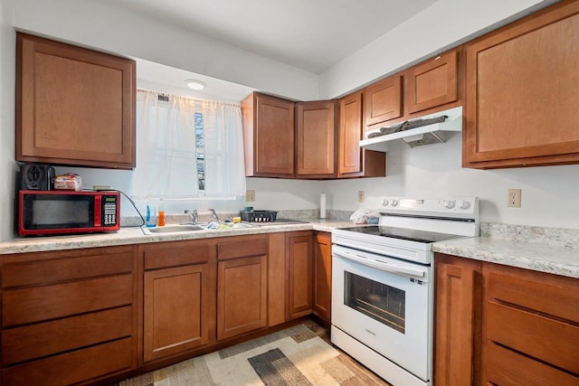 kitchen with electric stove, sink, and light wood-type flooring