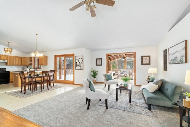 living room with vaulted ceiling, ceiling fan with notable chandelier, and light hardwood / wood-style floors