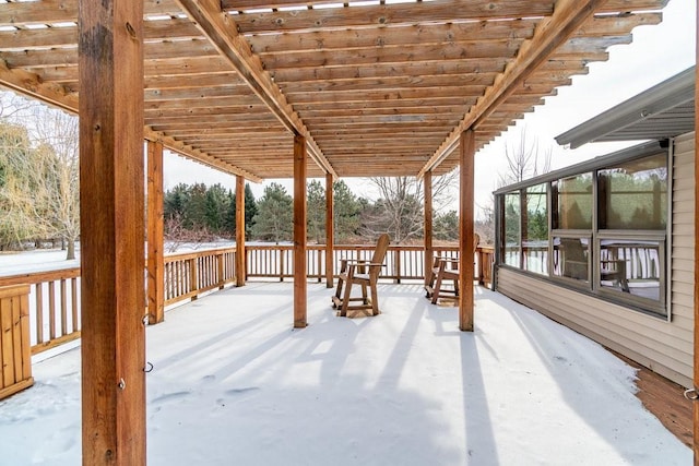 snow covered deck featuring a pergola