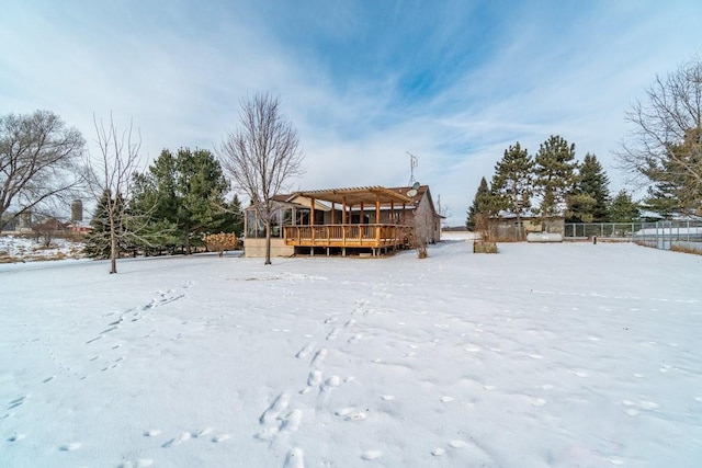 snowy yard featuring a wooden deck