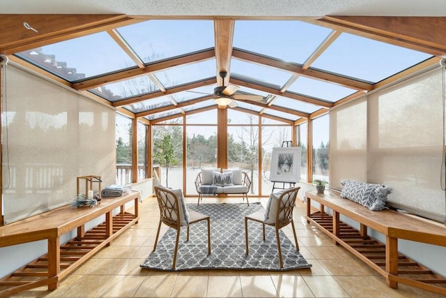 sunroom featuring plenty of natural light, lofted ceiling with skylight, and ceiling fan