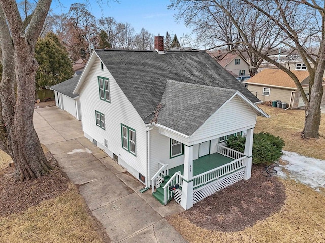 view of front of property with a porch, a garage, and an outdoor structure