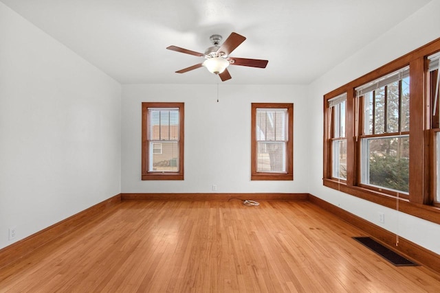 empty room with ceiling fan and light wood-type flooring