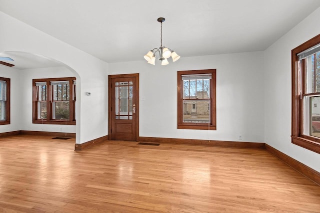 foyer entrance featuring light hardwood / wood-style floors and a chandelier