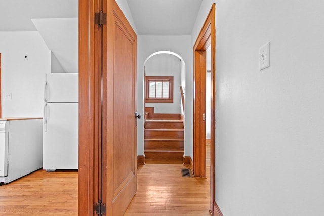 hallway with light hardwood / wood-style floors