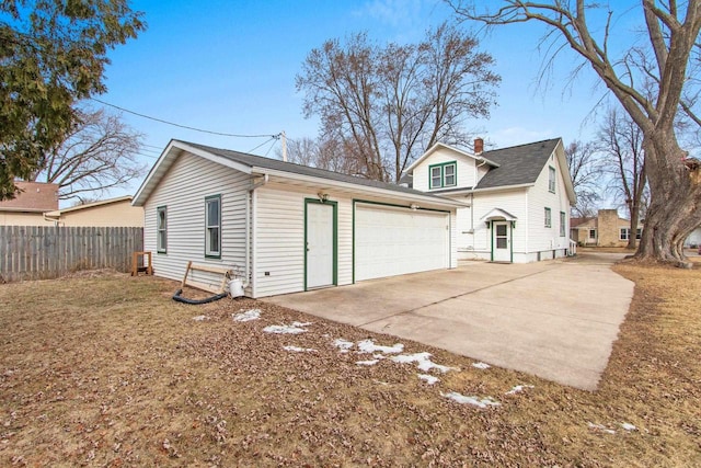 back of house with an outbuilding and a garage