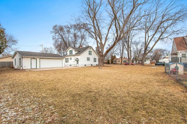 view of yard with a garage and an outbuilding