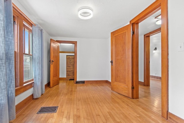 hallway with light hardwood / wood-style flooring