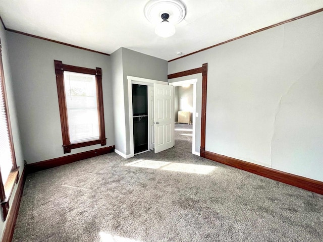 unfurnished bedroom featuring crown molding and carpet