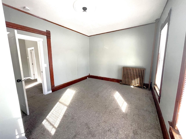 carpeted empty room featuring ornamental molding and radiator