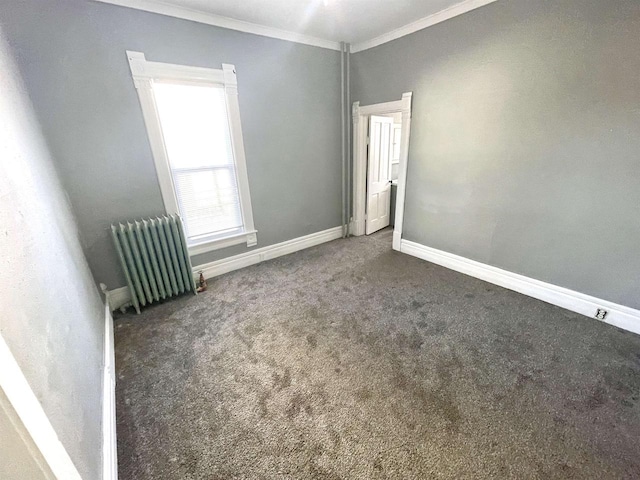 carpeted empty room with crown molding and radiator heating unit